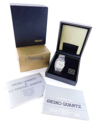 A Seiko quartz wristwatch, with 3cm wide compressed square dial with baton pointers and numerals, named Arabic date and a textured bracelet, in outer case with box and paperwork.