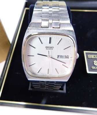 A Seiko quartz wristwatch, with 3cm wide compressed square dial with baton pointers and numerals, named Arabic date and a textured bracelet, in outer case with box and paperwork. - 2