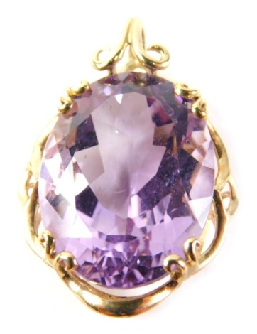 A 9ct gold amethyst pendant, the amethyst in scroll design, raised basket setting, 2.5cm high, 5.9g all in.