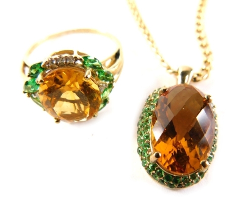 Two items of 9ct gold citrine and emerald set jewellery, comprising matching necklace and ring set, the ring with central citrine cluster, surrounded by emeralds and tiny diamonds in a raised basket, ring size S, the pendant of similar design, on a 9ct go