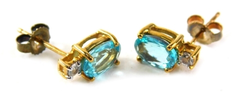 A pair of 9ct gold aquamarine and cz drop earrings, each with a single pin back on later butterfly backs, 1.4g all in.