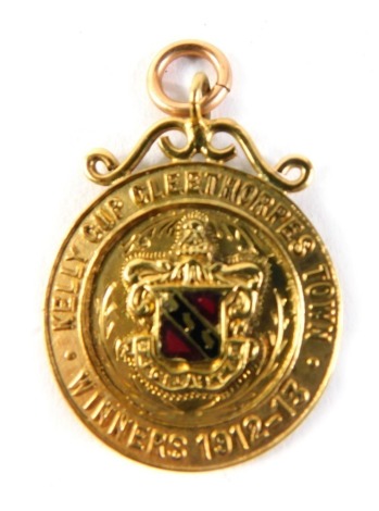 A 9ct gold Kelly's Cup Cleethorpes Town winners fob, dated 1912-13, with enamel shield front and plain hook top, 4cm high, 6g all in.