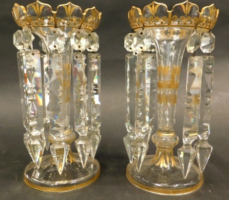 A late 19thC clear glass and gilt decorated table lustres, each with prismatic drops on a domed foot (AF), 24cm high.