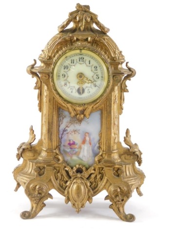 A late 19thC French gilt metal mantel timepiece, the dial with Arabic numerals and decorated with floral swags, above a porcelain panel painted with a female figure and a musician, the case decorated overall with leaves, scrolls, flowers, etc., 28cm high.