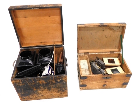 A late 19thC matched pair of magic lanterns, in black tin, and another with slide sections, in a fitted box, further accessories and items for adjustments to the the magic lanterns, and a quantity of wooden framed magic lantern slides in colours, other wo