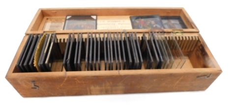 A quantity of early late 19thC and early 20thC magic lantern slides, in a box marked Religion, a quantity of sets, one labelled L A Jesus GE Gautscuf, each approx 8cm high, in pine box. (a quantity)