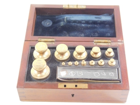 A set of standard apothecaries weights, made for the City of Lincoln, Trading Standards label for Doyle and Sons, London, in a mahogany case, 19cm wide.