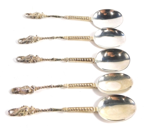 A set of five dragon topped George V silver teaspoons, with elaborate handles, London 1922 and 1923, 12cm long, 2.8oz.