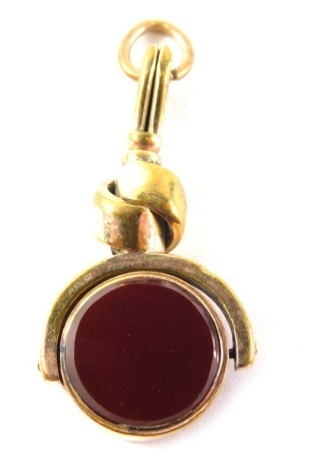 A watch fob with rotating polished green and brown stones, with circular hook top, unmarked, 3cm high.