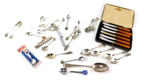 A quantity of various silver and silver plated flatware, part cased set, with amber coloured handles, collectors spoons, silver teaspoons, etc. (a quantity)