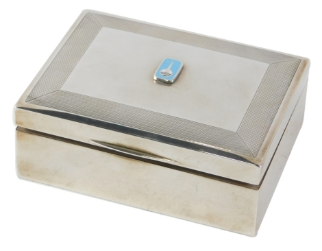 An Elizabeth II silver cigarette box, with domed lid centred by an emblem with engine turned outline, cedar lined interior, Birmingham 1969, 12cm wide, 9.8oz all in.