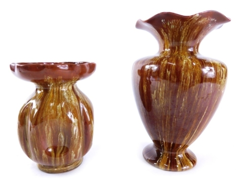 A Linthorpe pottery vase, with floral neck, shouldered body and circular foot, no. 1679, in running glazes of brown and yellow, impressed marks beneath, 16cm high, and a similar vase no. 2178. (2)