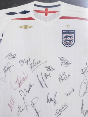 An England football shirt 2007-2009, bearing various signatures 80cm x 53cm, Including a facsimile sheet of various signatures. (2)