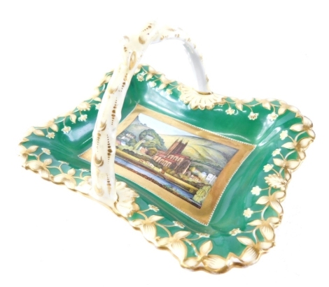 A 19thC porcelain basket, hand painted to the centre with a scene of church and buildings, with a outer floral decoration, on green ground with gilt highlights, unmarked, 18cm wide.