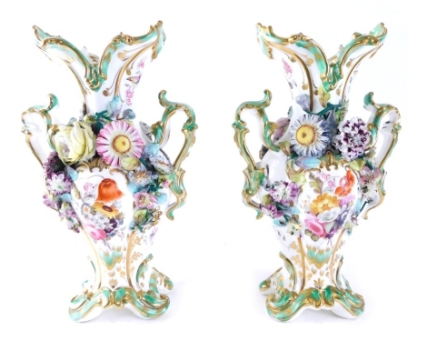 A pair of Coalport type porcelain vases, each profusely decorated with raised flowers, hand painted with further panels of flowers with gilt highlights on a green and white ground, unmarked, 29cm high.