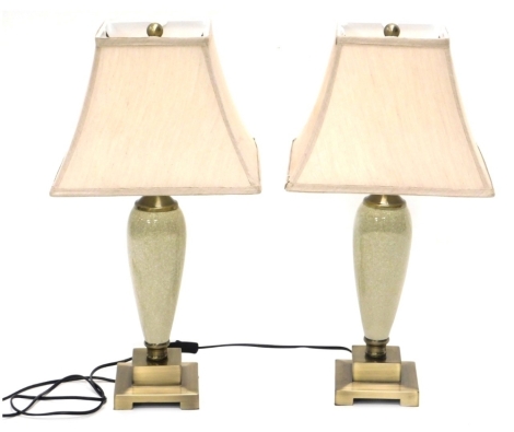 A pair of decorative crackle glazed table lamps, with cream shades, on stepped bases, 60cm high, and three further table lamps. (a quantity)