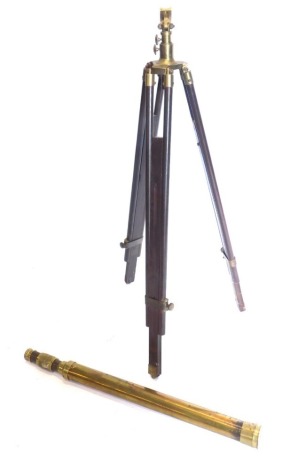 A brass telescope, when closed 77cm long, on a tripod stand with brass fittings.