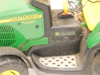 A child's John Deere two speed battery powered tractor, 60cm high, with trailer, leads and other accessories. - 2