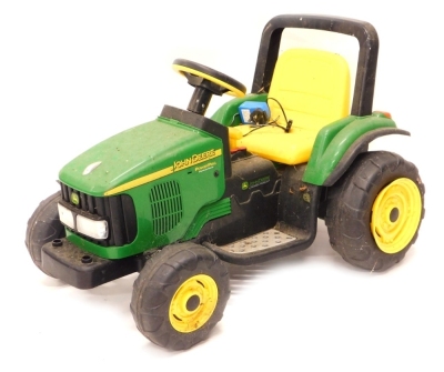 A child's John Deere two speed battery powered tractor, 60cm high, with leads and other accessories.