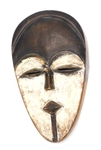 An African tribal Sango wall mask, picked out in white, 35cm high.