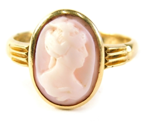 An 18ct gold cameo dress ring, the cameo depicting maiden looking right, in pale pink with reeded shoulders, ring size O, 3.5g all in.