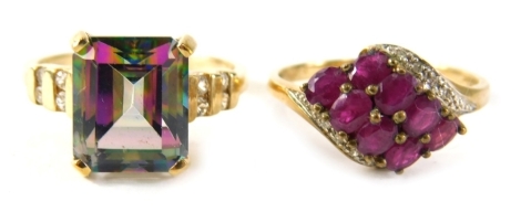 Two 9ct gold dress rings, comprising a garnet and cz twist ring, ring size S and a mystic topaz basket setting ring, ring size S, 8.1g all in. (2)