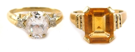 Two dress rings, comprising a 9ct gold citrine cz staggered shoulder set dress ring, ring size S, and a 9ct gold and cz set single stone ring size S. 7.2g all in. (2)