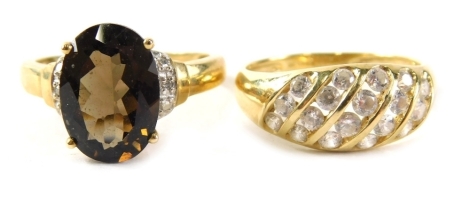 Two 9ct gold dress rings, comprising a smoky quartz and CZ cluster ring, ring size S½, a five row CZ panel ring, ring size S 7.6g all in.