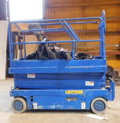 An access working platform scissor lift. VAT is also payable on the hammer price of this lot.