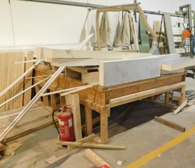 A wooden bench with a quantity of wood and insulation. VAT is also payable on the hammer price of this lot.