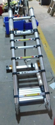 A collapsible surveyor's folding and extending ladder. VAT is also payable on the hammer price of this lot. - 2