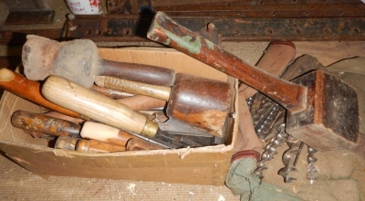 A collection of chisels, mallets and wood drills.