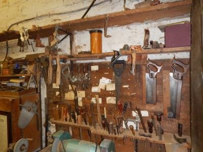 Various woodworking tools, including spoke shaves, tenon saws, mallets, etc.