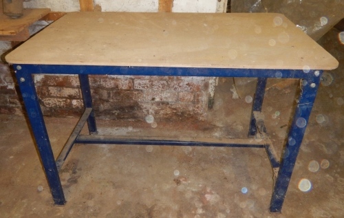 Metal frame work bench with plywood top.