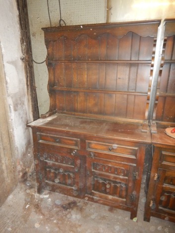 An oak dresser with linenfold panelled doors, 115cm x 175cm.