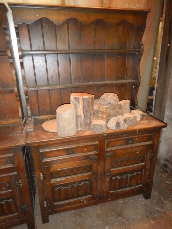 An oak dresser with linenfold panelled doors, 115cm x 175cm.