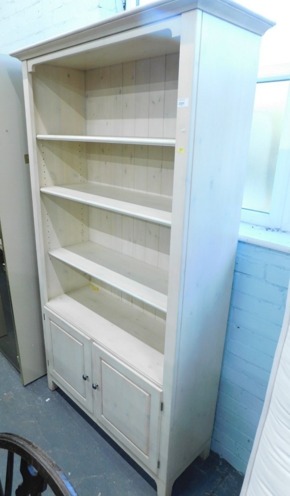 A Ducal pine open display with double cupboard beneath.