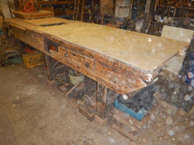 A large Victorian pine work bench, fitted with a drawer, and three Record bench vices, 335cm x 97cm x 92cm high.