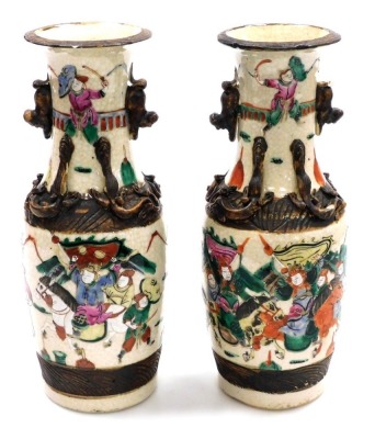 A pair of Chinese crackle glaze vases, of baluster form, with applied dog of fo handles and chilin to the neck, the body depicting a battle scene with figures on horseback, four character mark, 29.5cm high. - 12