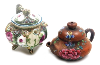 Two miniature teapots, comprising a Chinese Yixing example, decorated in enamels with flowers and butterflies, 4cm high, (AF), and a Japanese Nippon moriage decorated teapot, 5cm high. - 10