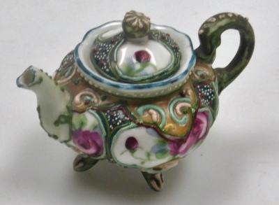 Two miniature teapots, comprising a Chinese Yixing example, decorated in enamels with flowers and butterflies, 4cm high, (AF), and a Japanese Nippon moriage decorated teapot, 5cm high. - 11