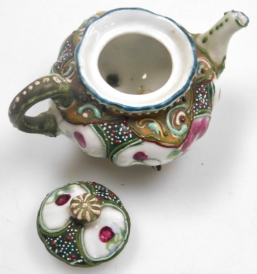 Two miniature teapots, comprising a Chinese Yixing example, decorated in enamels with flowers and butterflies, 4cm high, (AF), and a Japanese Nippon moriage decorated teapot, 5cm high. - 13