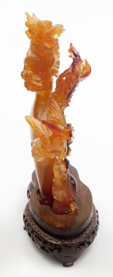 A Chinese agate carving of a vase, enveloped with two dragons and a flaming pearl, terrapin, and a ho-ho bird, raised on a hardwood stand, 21m high, (AF). - 10