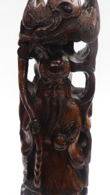 A 20thC Chinese hardwood carving of Shou Lao, the figure holding staff and a peach above a three clawed dragon, 56cm high. - 11