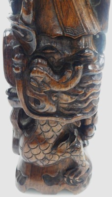 A 20thC Chinese hardwood carving of Shou Lao, the figure holding staff and a peach above a three clawed dragon, 56cm high. - 12