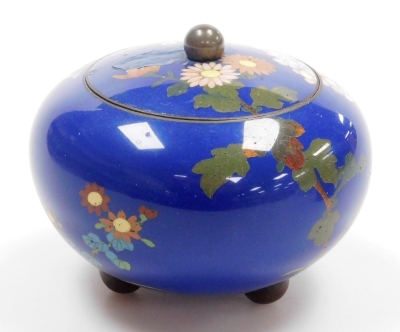 A Japanese Meji period cloisonne enamel koro and cover, of globular form, decorated with flowers, blossom and butterflies on a blue ground, on three bun feet, 10cm wide, together with a Japanese Meiji period cylindrical box and cover decorated with flower - 16