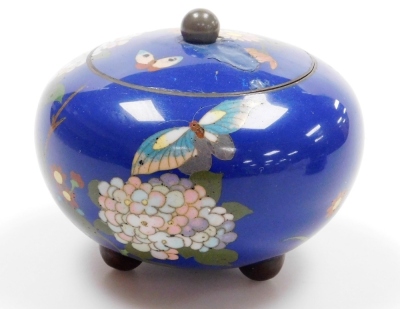 A Japanese Meji period cloisonne enamel koro and cover, of globular form, decorated with flowers, blossom and butterflies on a blue ground, on three bun feet, 10cm wide, together with a Japanese Meiji period cylindrical box and cover decorated with flower - 17