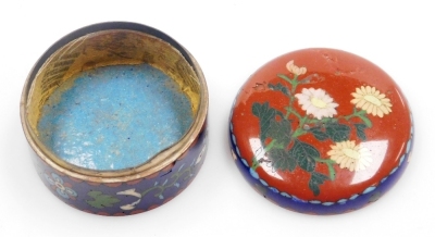 A Japanese Meji period cloisonne enamel koro and cover, of globular form, decorated with flowers, blossom and butterflies on a blue ground, on three bun feet, 10cm wide, together with a Japanese Meiji period cylindrical box and cover decorated with flower - 21