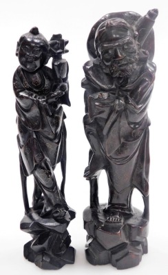 Two Chinese hardwood figures of deities, with silver wirework inlay, 29cm high and 28cm high, and two figures modelled as boys riding on buffaloes, 12cm wide. - 19