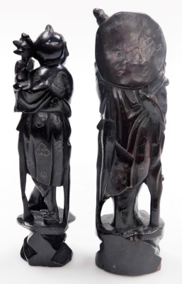 Two Chinese hardwood figures of deities, with silver wirework inlay, 29cm high and 28cm high, and two figures modelled as boys riding on buffaloes, 12cm wide. - 21